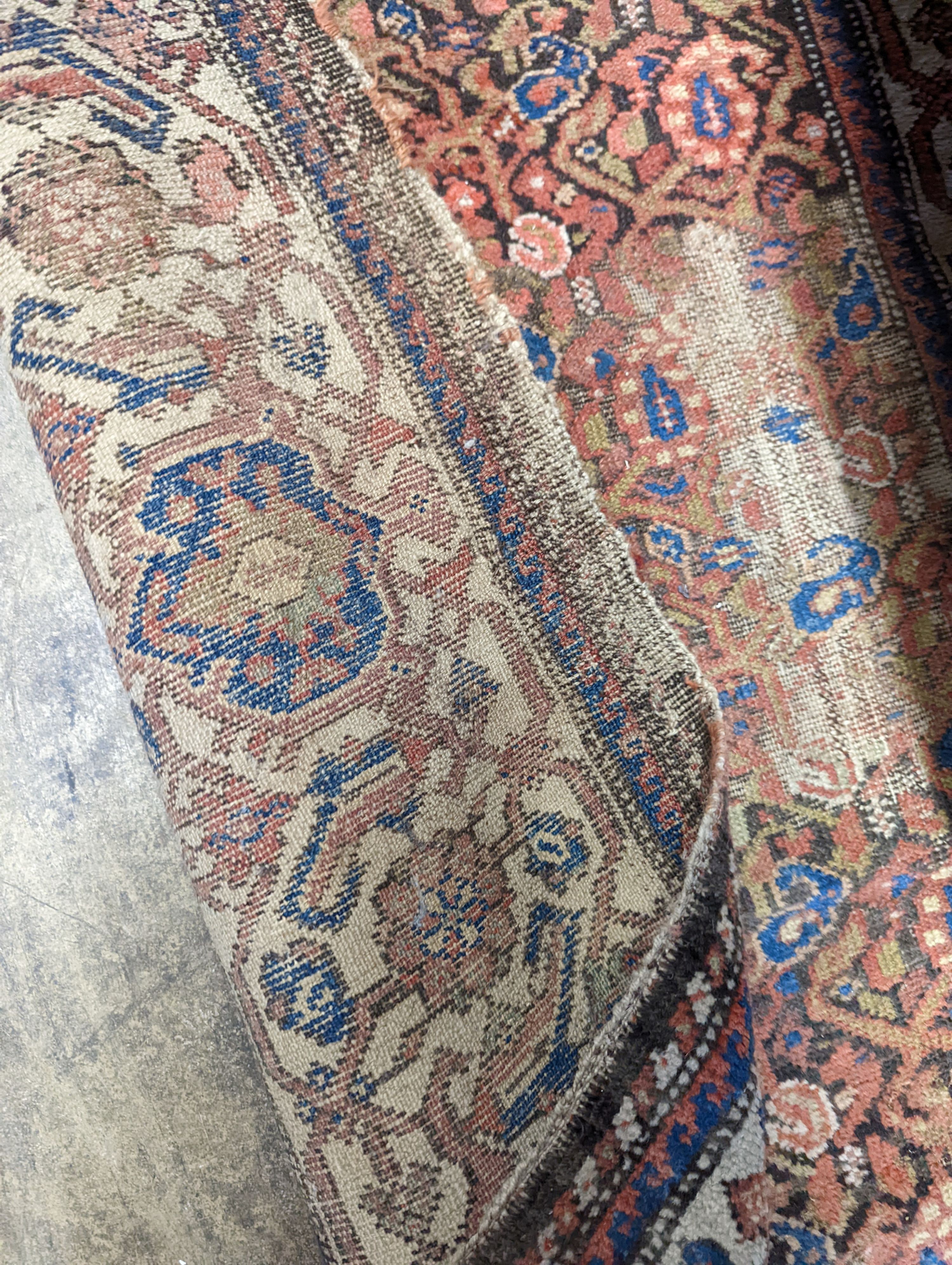 A Persian black ground runner, the central field including boteh motifs, 280 x 106cm, worn
